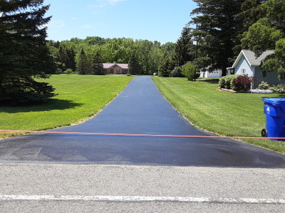 Freshly sealcoated residential driveway in Lockport, NY neighborhood
