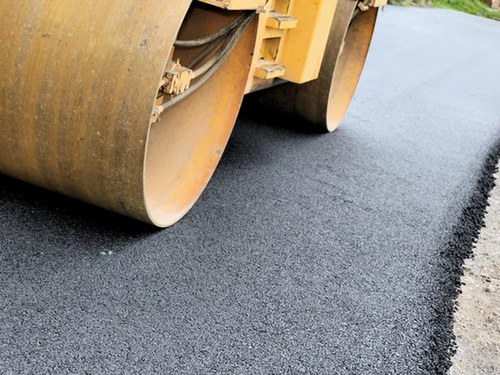 Asphalt paving crew laying fresh blacktop in Lockport, NY